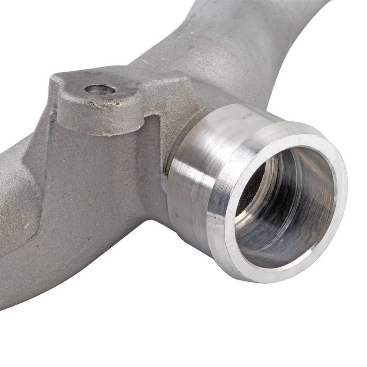 Close-up of silver coolant pipe with threaded outlet and machined metal fitting