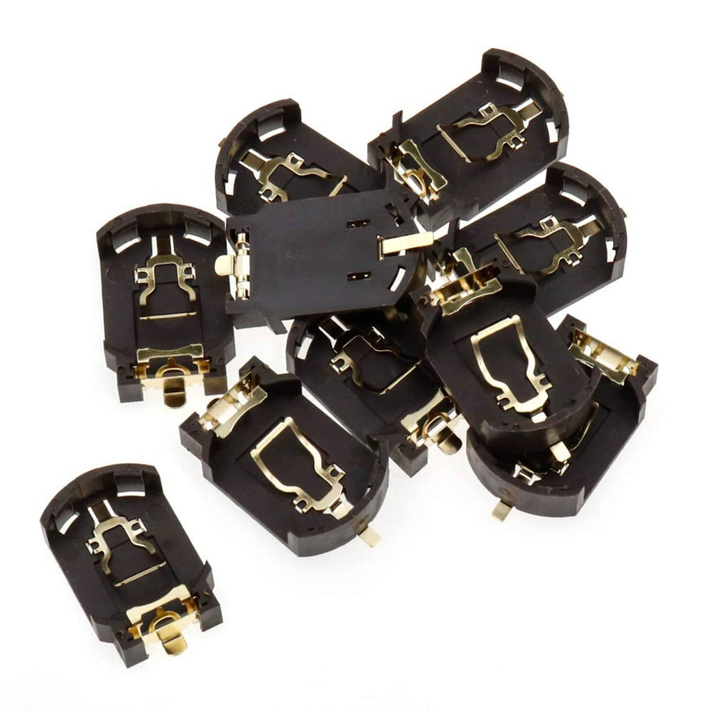 Various CR2032 holder pieces, black plastic with gold contacts