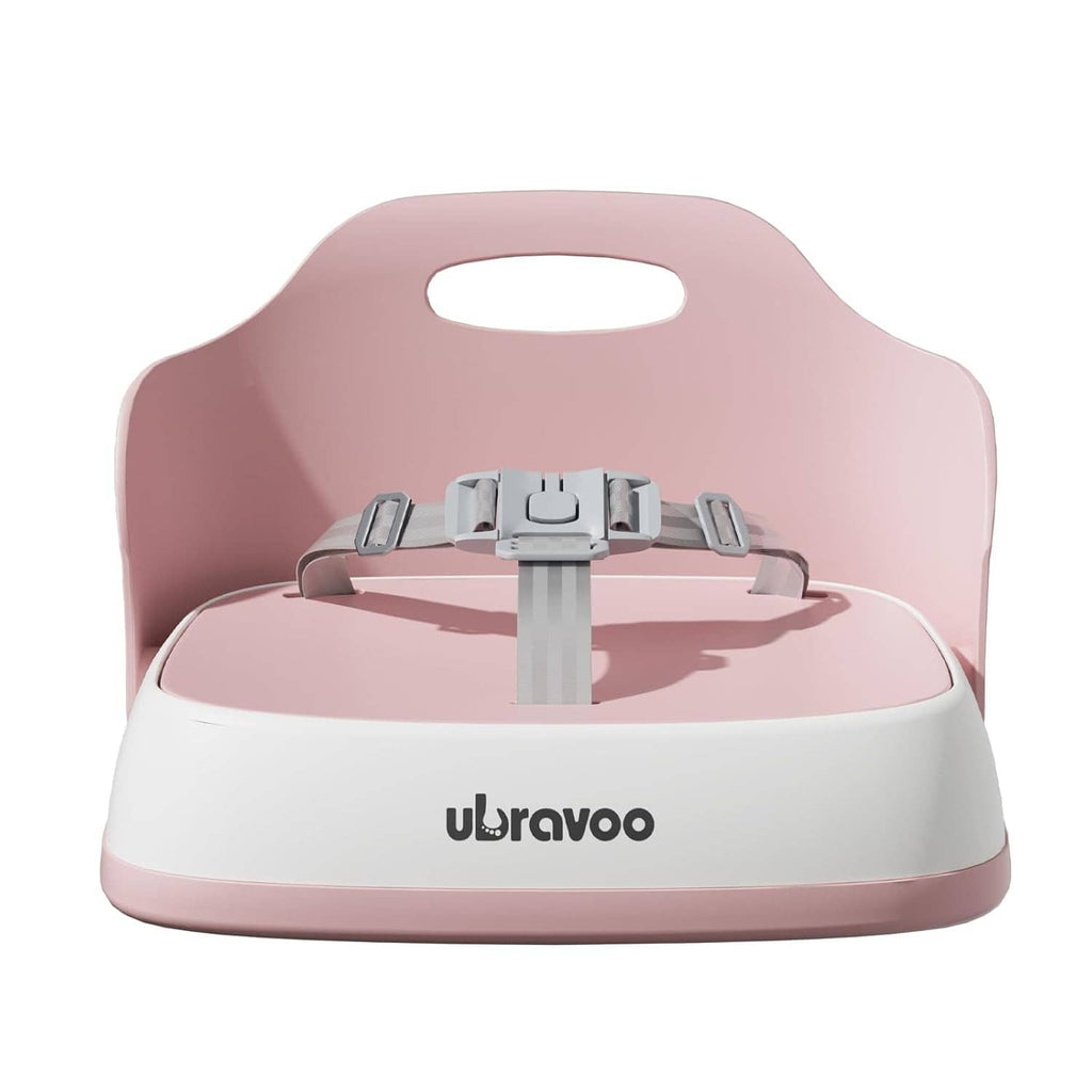 Pink and white booster seat with gray safety buckle on a molded seat base