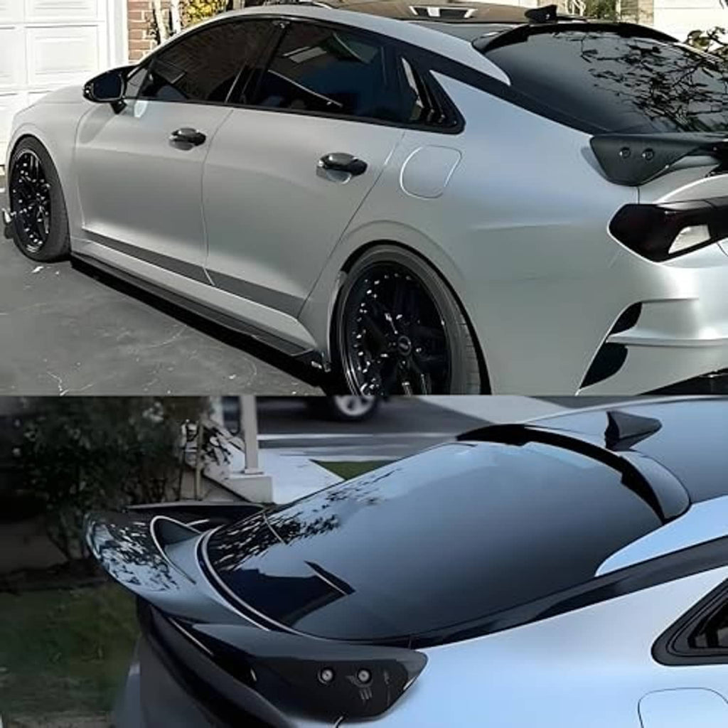 Black roof spoiler wing installed on a white car, shown with a close-up view.