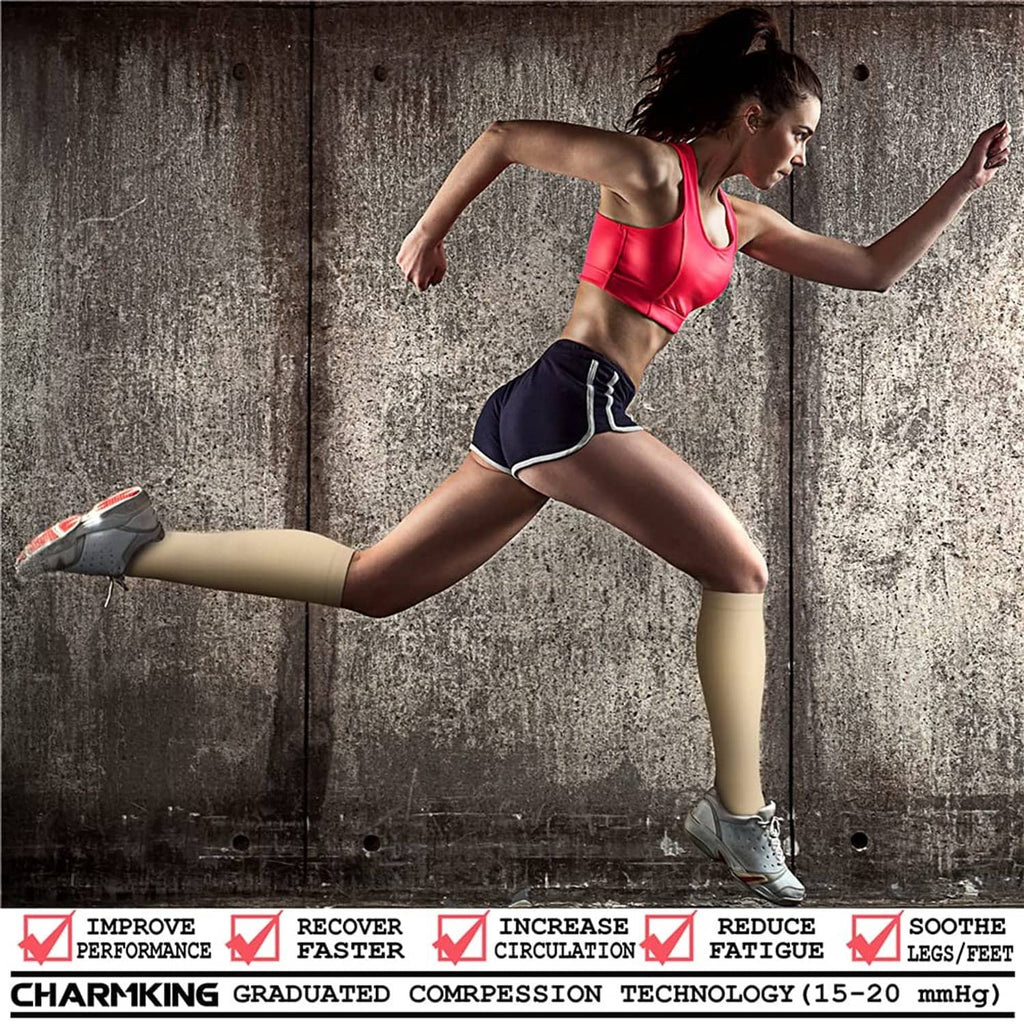 Beige graduated compression socks on a runner’s calves during exercise