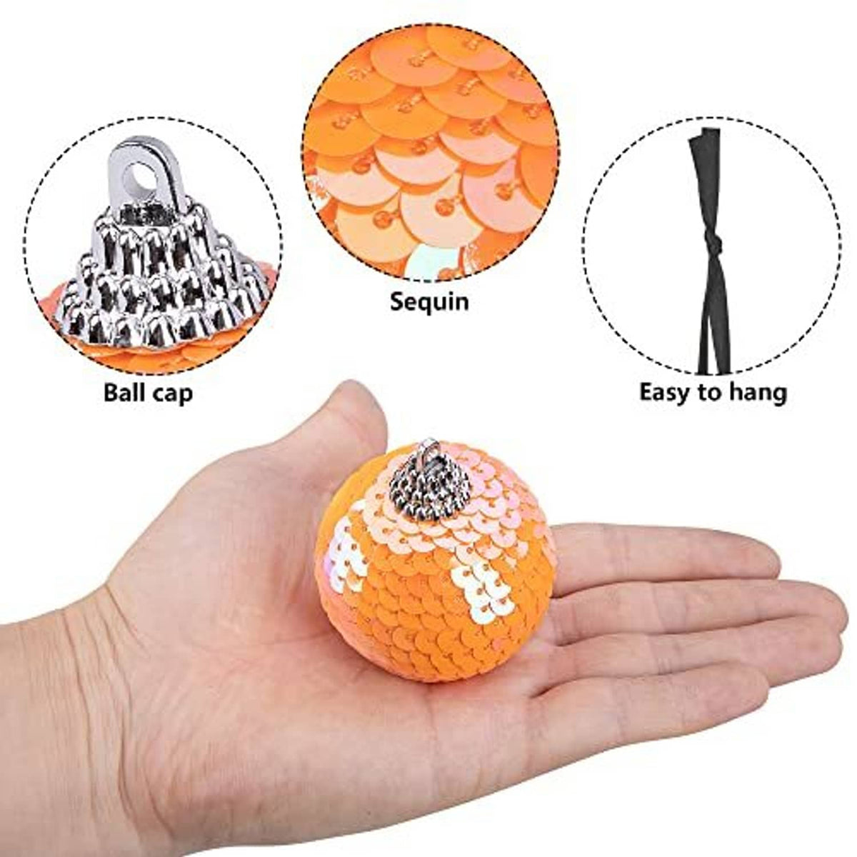 Orange sequin hanging ball ornament with silver cap, held in a hand for size