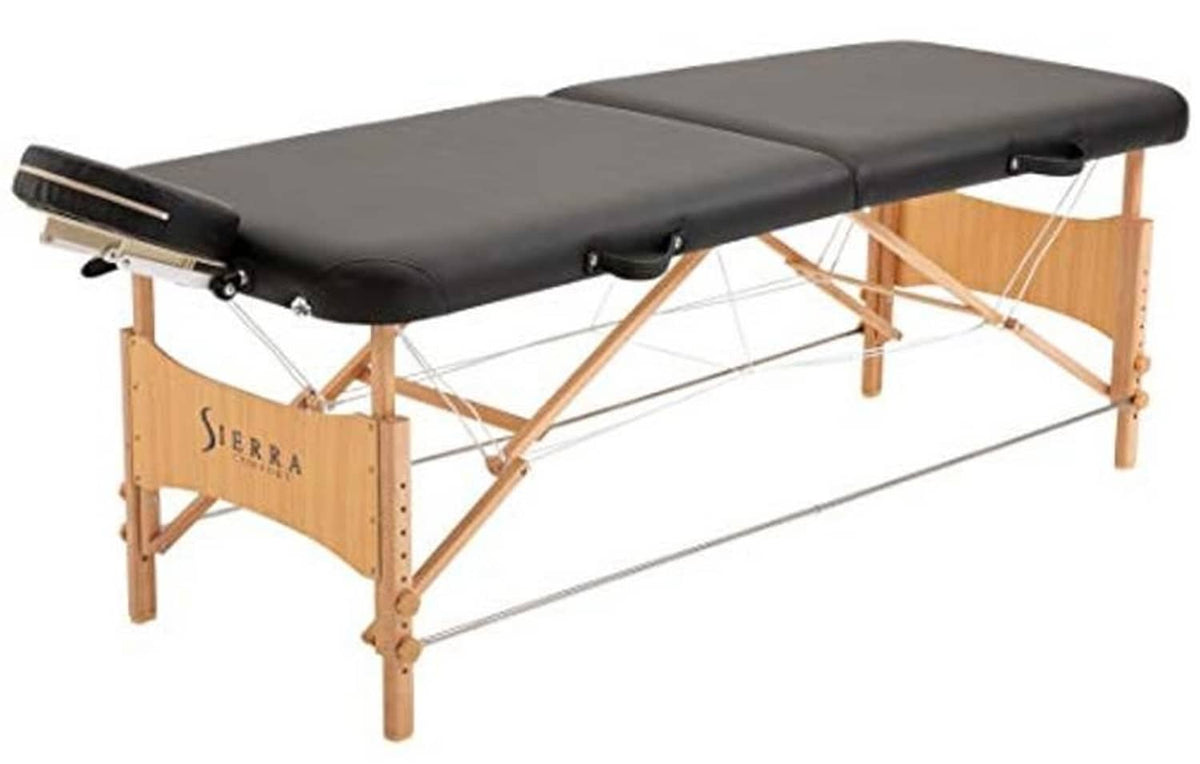 Portable massage table with black padded top and wooden frame with support straps