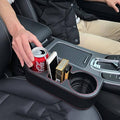 Black car seat console organizer with cup holder and two phone slots, red contrast stitching