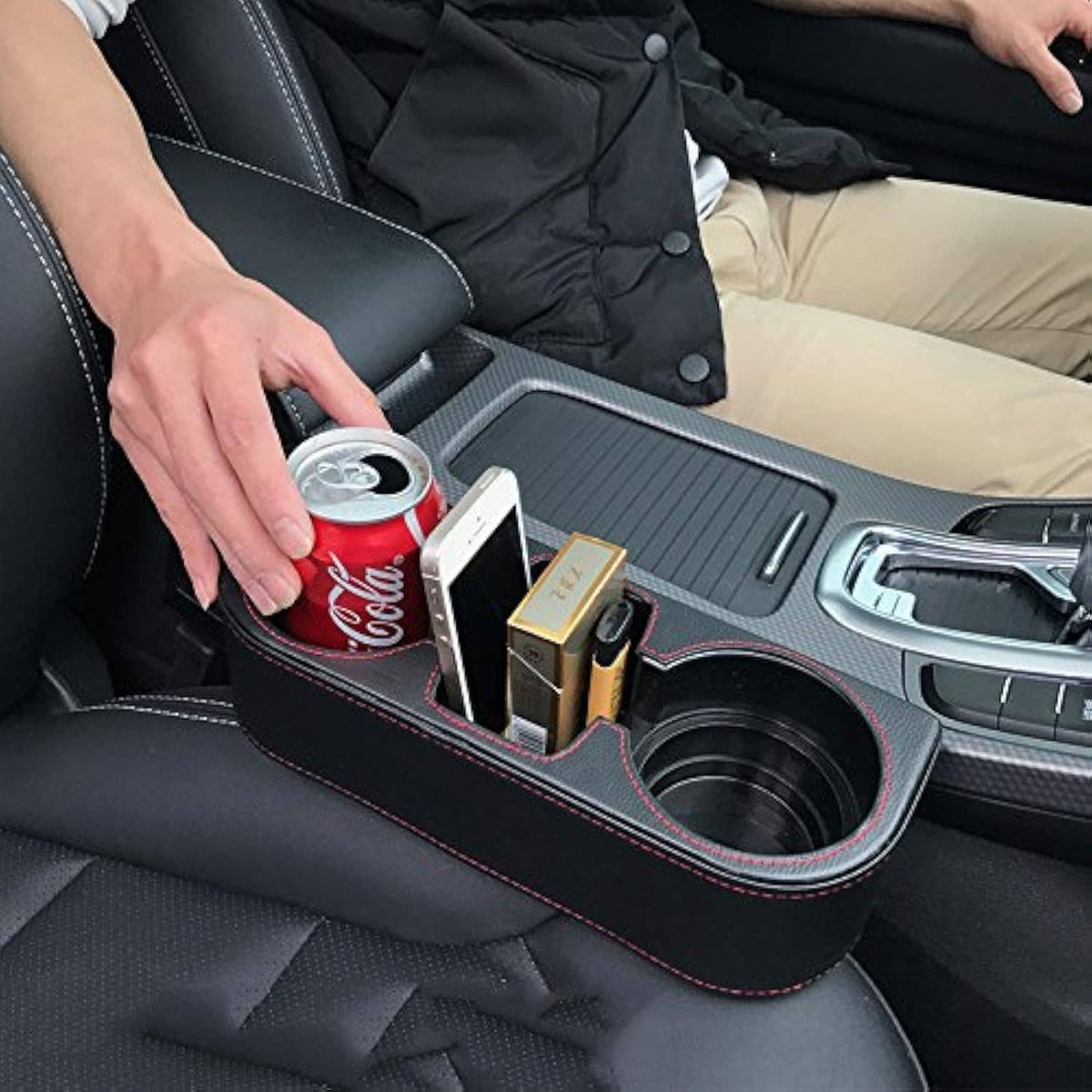 Black car seat console organizer with cup holder and two phone slots, red contrast stitching