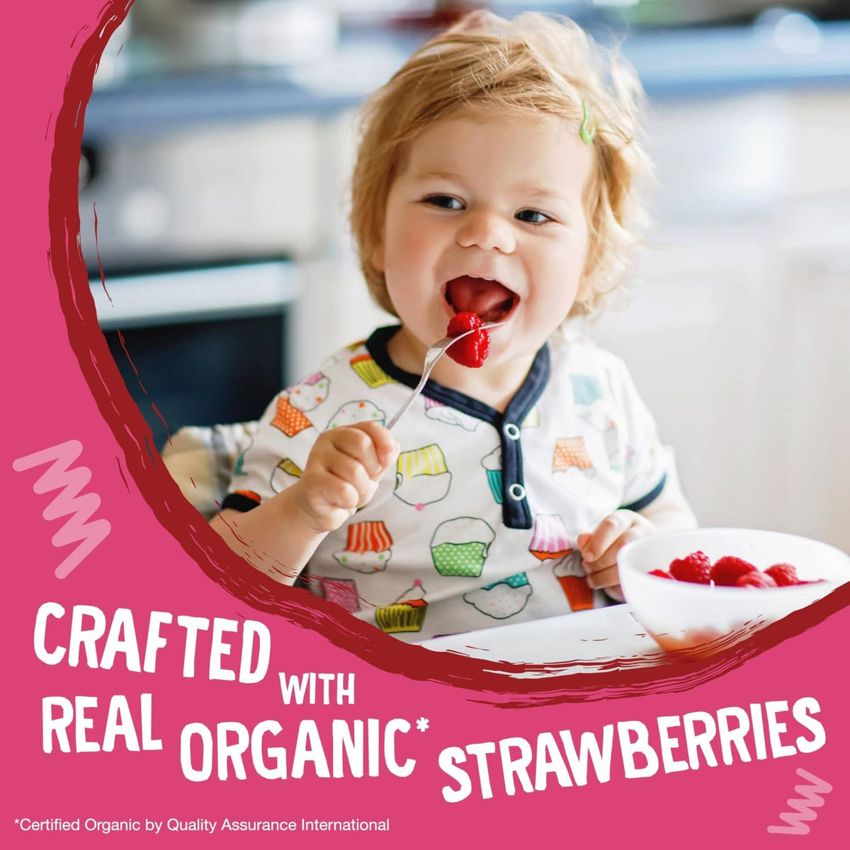 Toddler eating strawberry snack bar with text 'Crafted with real organic strawberries'