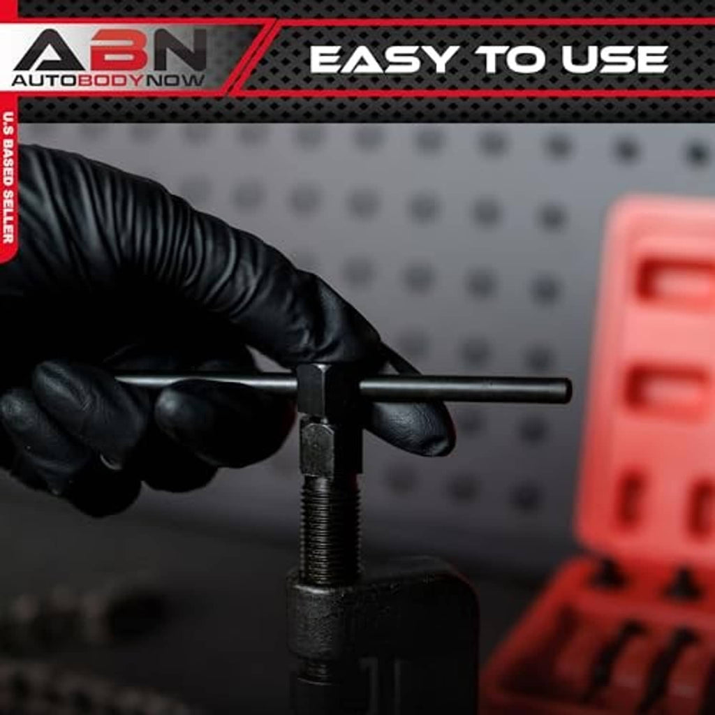 Chain breaker riveter tool with black lever and threaded screw, close-up on bench