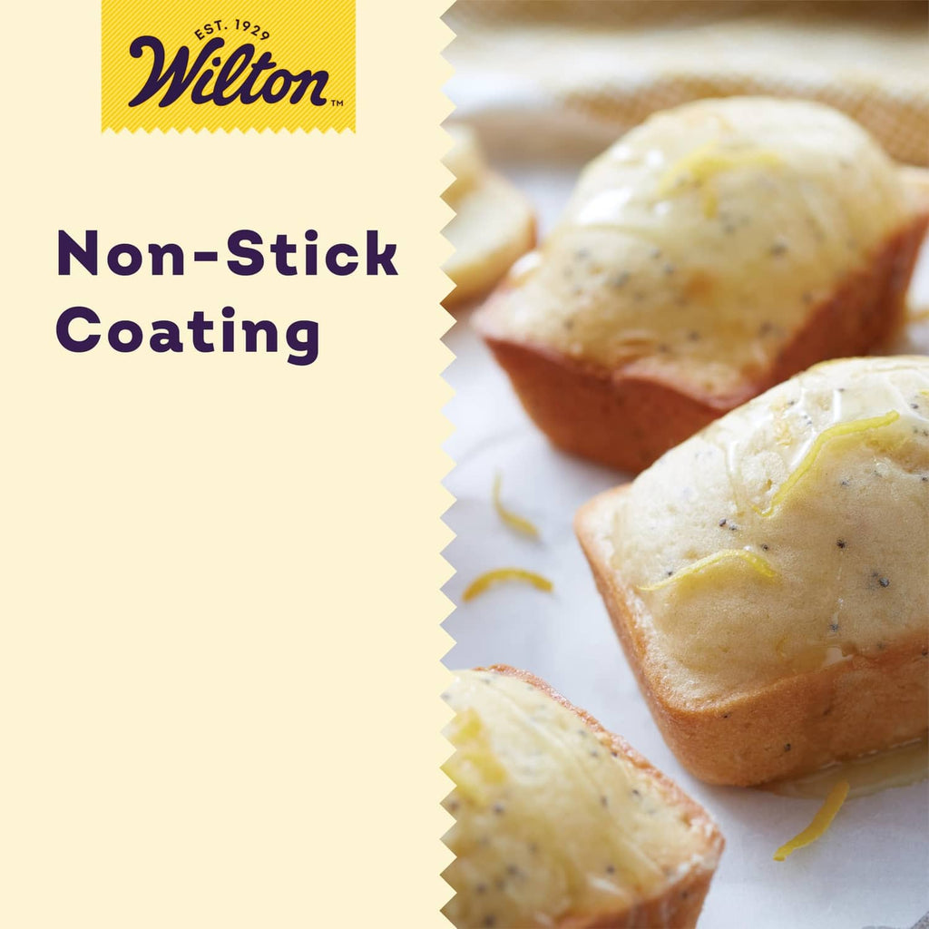 Non-stick mini loaf pan set with baked mini loaves on a white serving plate