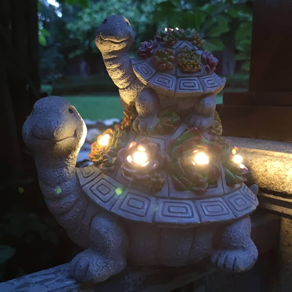 Solar tortoise garden lantern statue with glowing warm LEDs and multicolor flower top