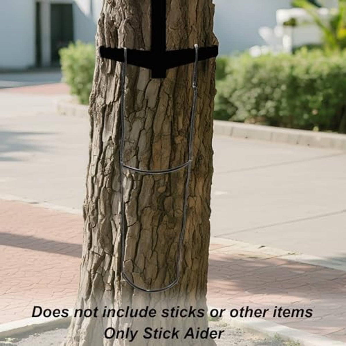 Tree-mounted climbing stick aider with black strap and curved two-step platform