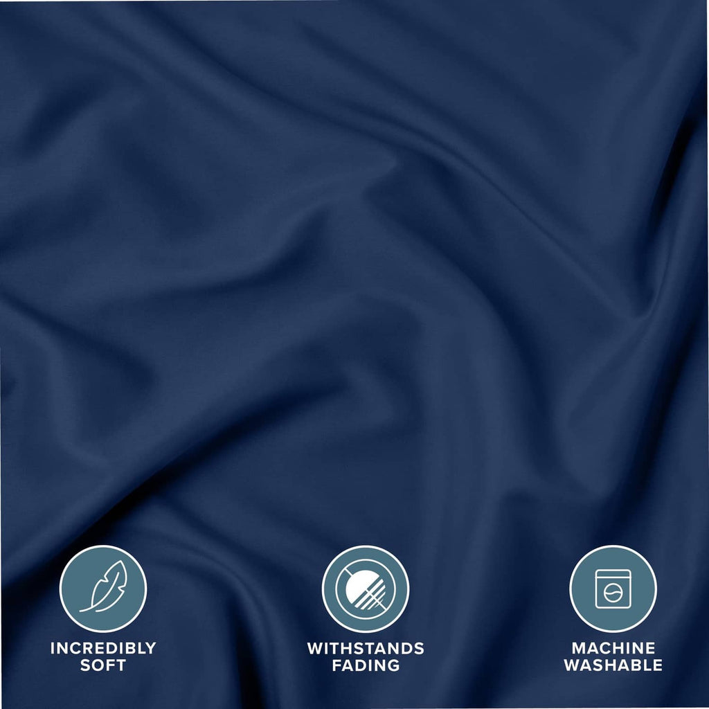 Dark blue microfiber pillow sham fabric close-up with soft, wrinkle texture