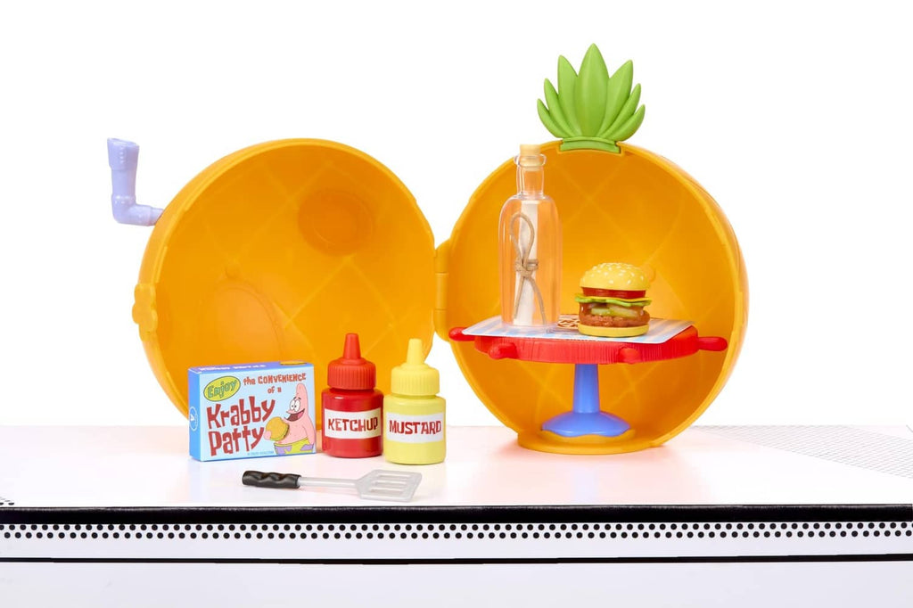 Opened orange capsule with mini burger stand, condiment containers and small tools