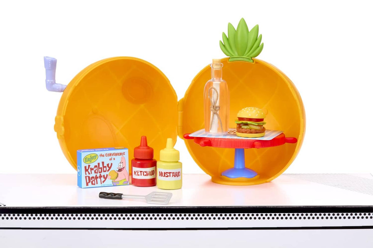 Opened orange capsule with mini burger stand, condiment containers and small tools
