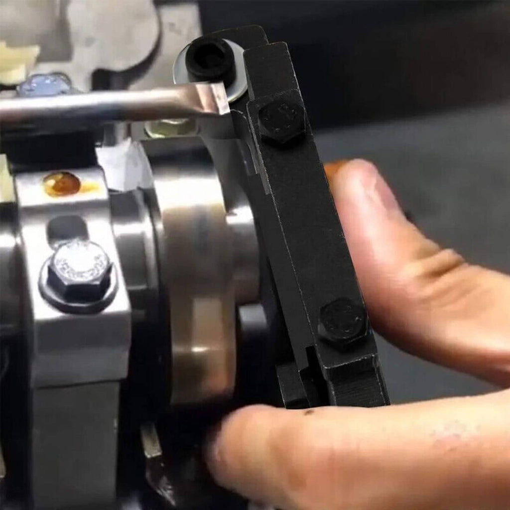 Camshaft timing tool clamp positioned on engine near camshaft housing