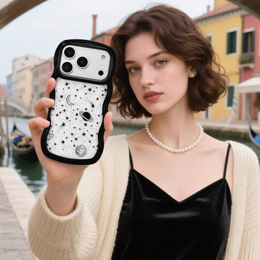 iPhone Pro Max case held outdoors, black wave frame with white star and planet print