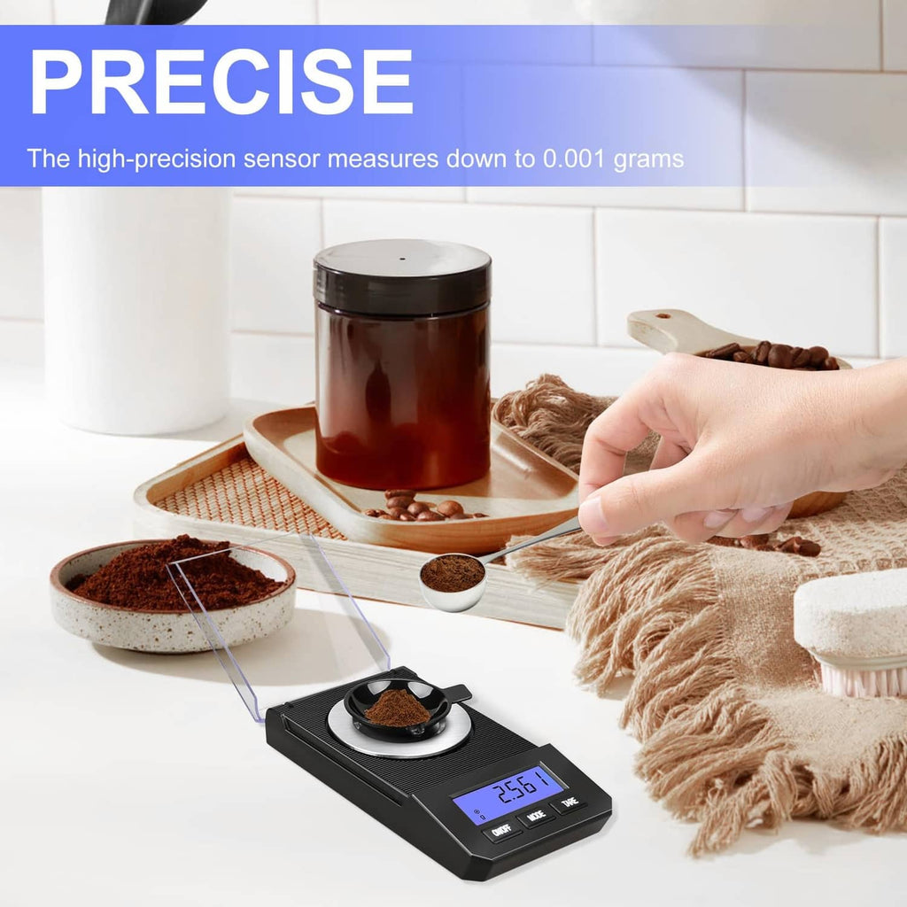 Black digital milligram scale with glass cover and round metal weighing dish
