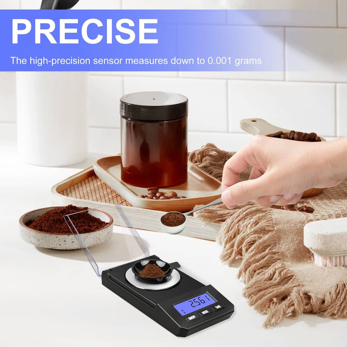 Black digital milligram scale with glass cover and round metal weighing dish