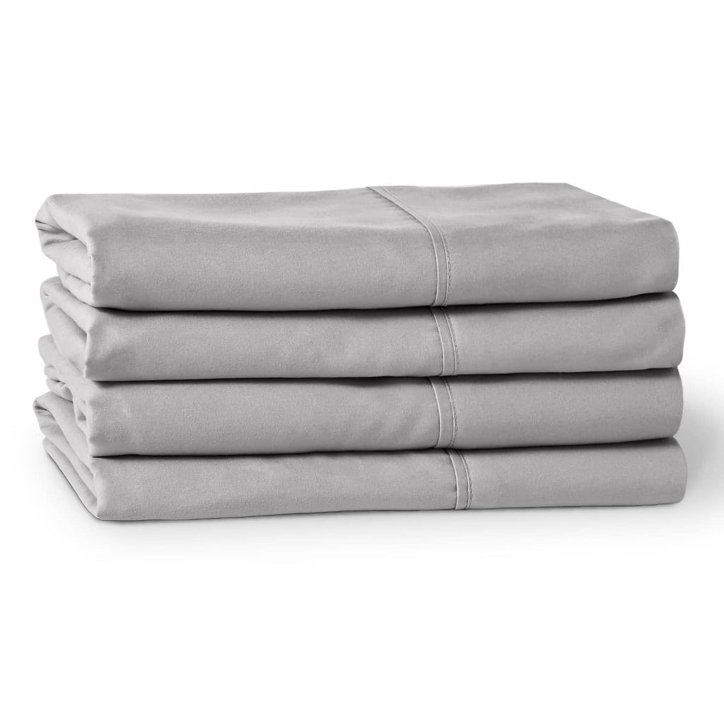 Light gray microfiber pillowcases folded in a stack, with stitched borders