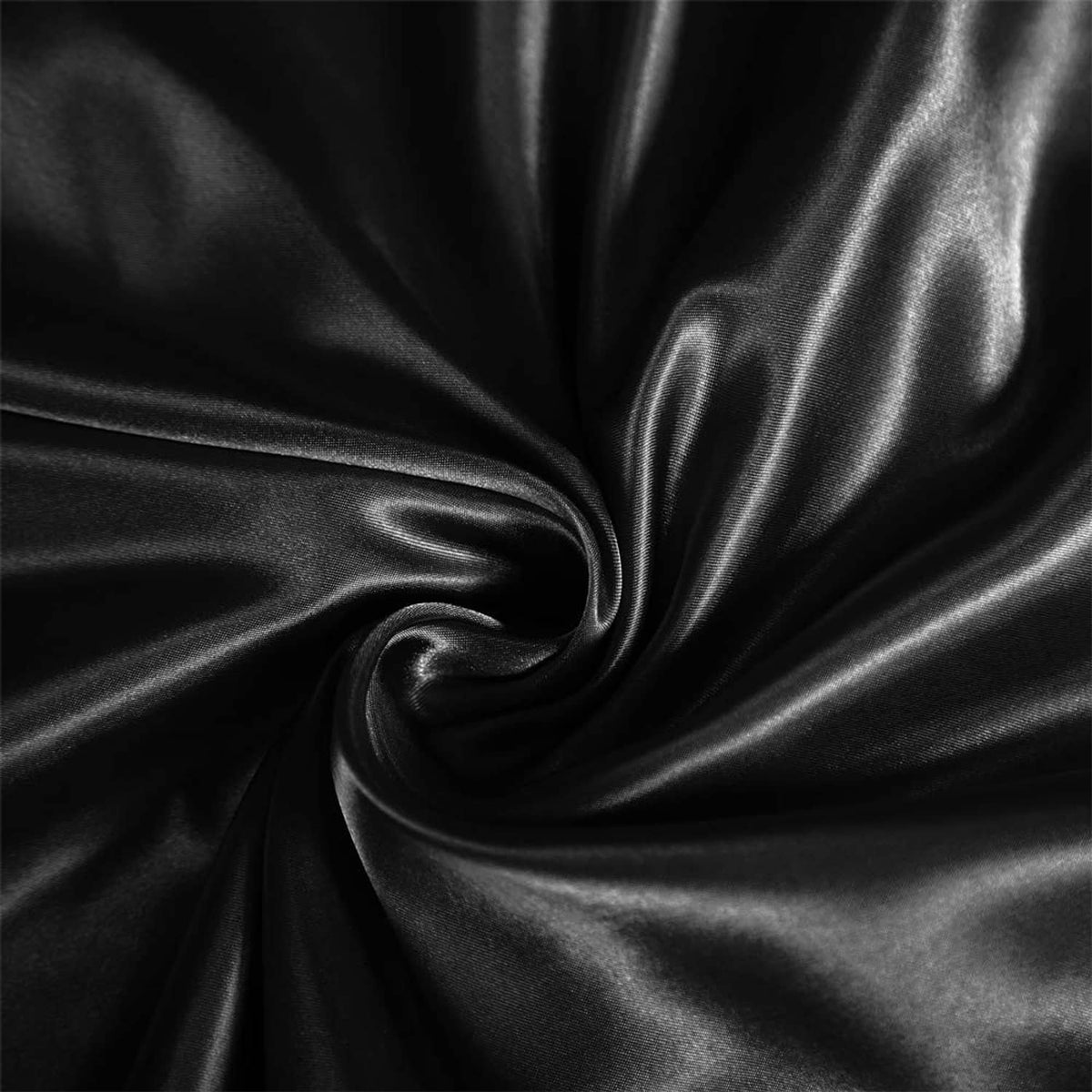 Close-up of black satin fabric sheen with soft folds and stitching