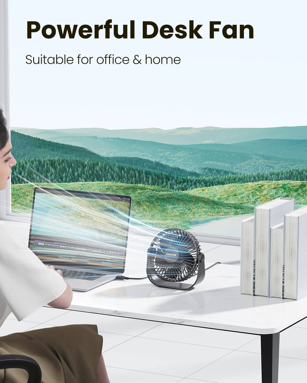 Black USB desk fan on a white desk, compact tabletop design