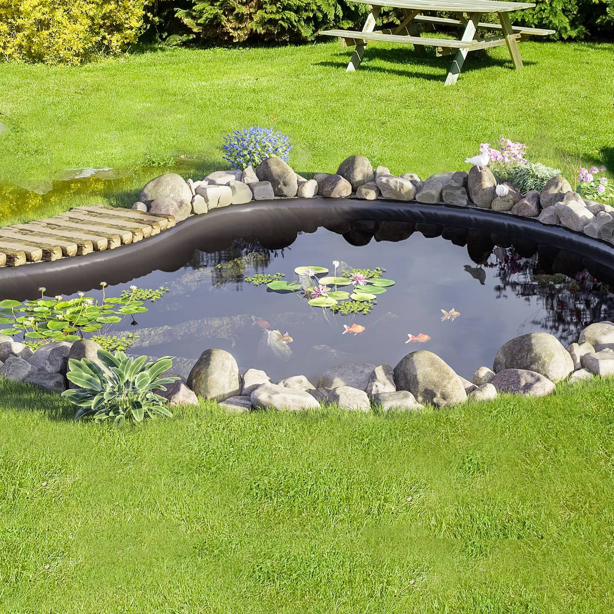 Black pond liner installed under water and rocks in a backyard fish pond