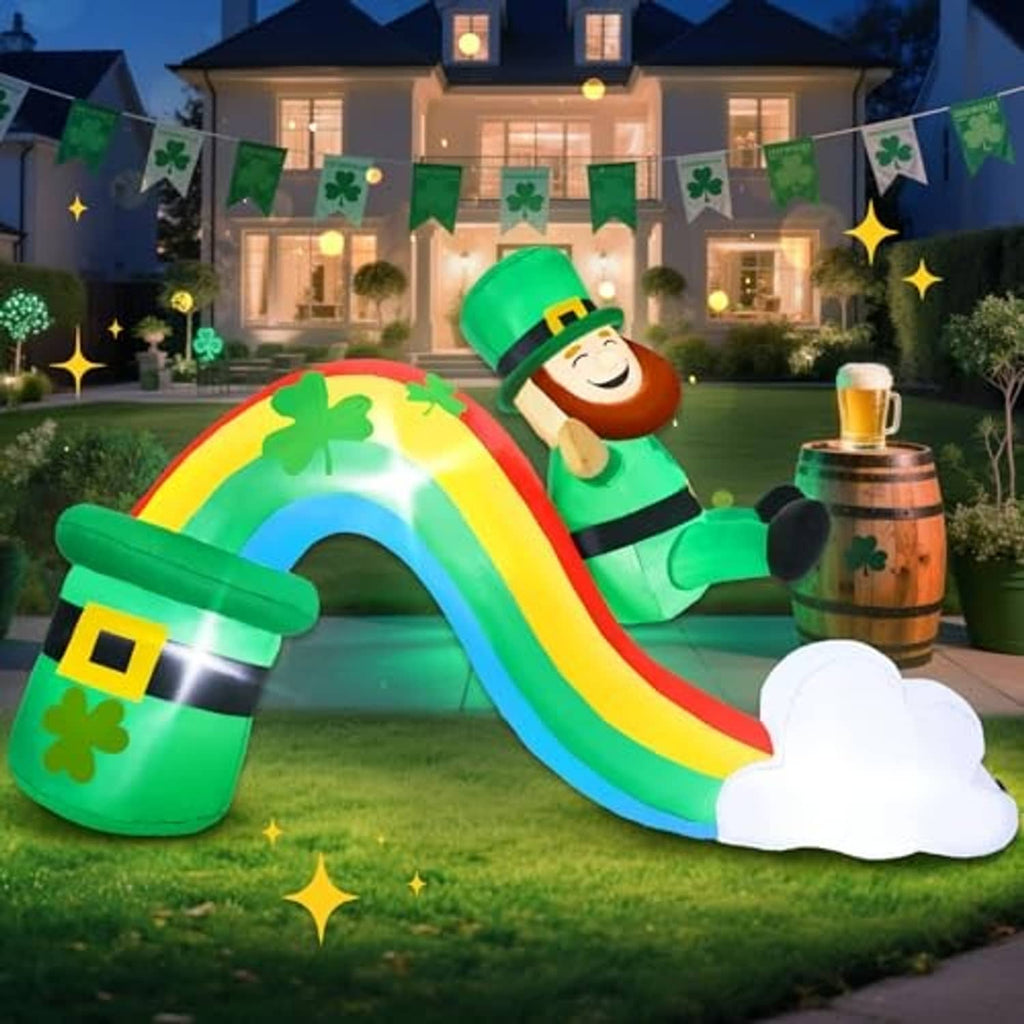 Inflatable rainbow slide with leprechaun, green clover pot, and white clouds at dusk