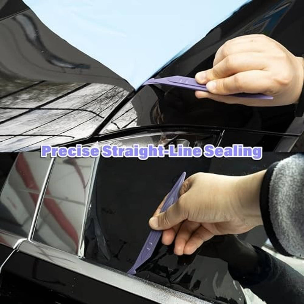 Hands press vinyl wrap along a car panel seam with a purple double-edge tool