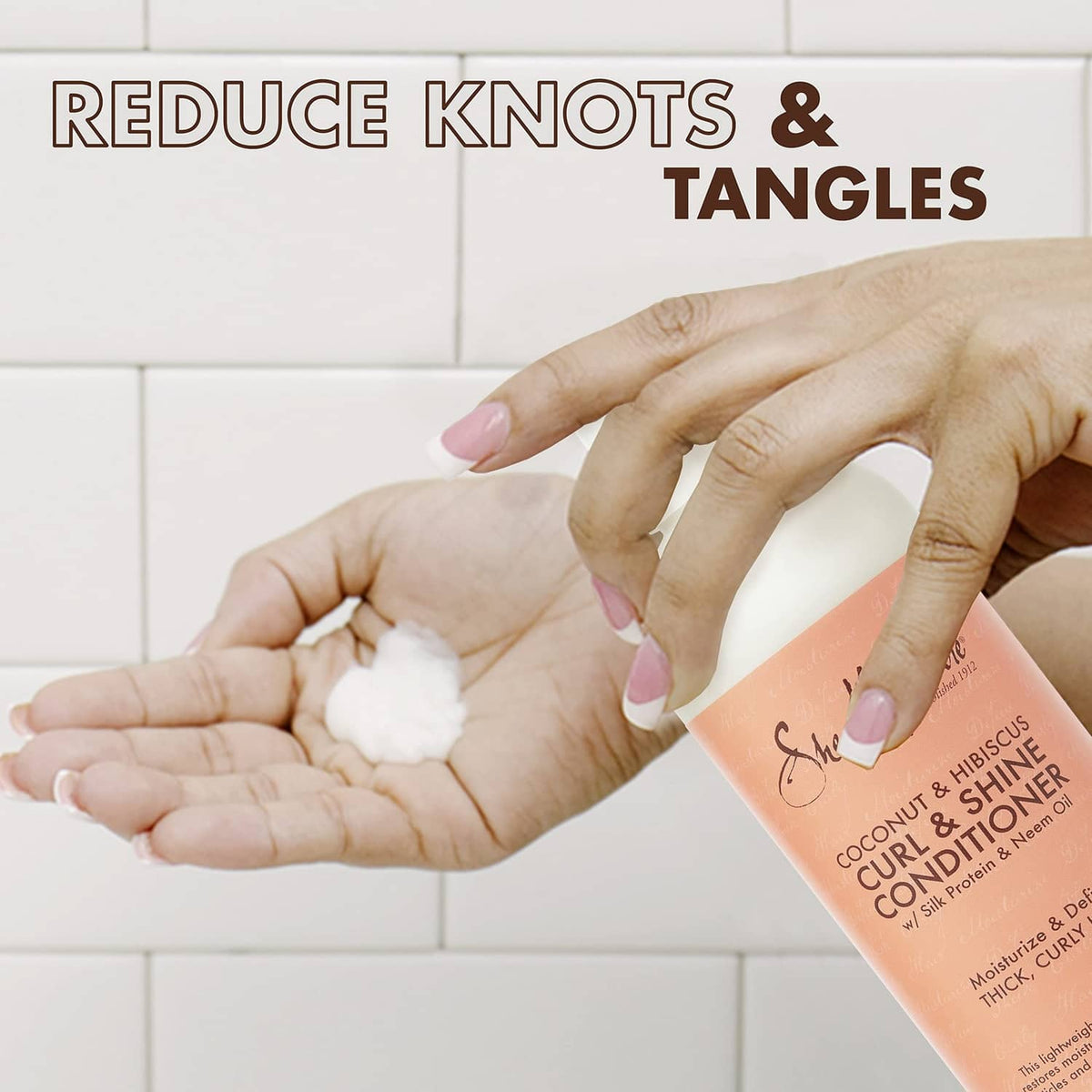 Curl & Shine conditioner bottle held while squeezing creamy foam into hand