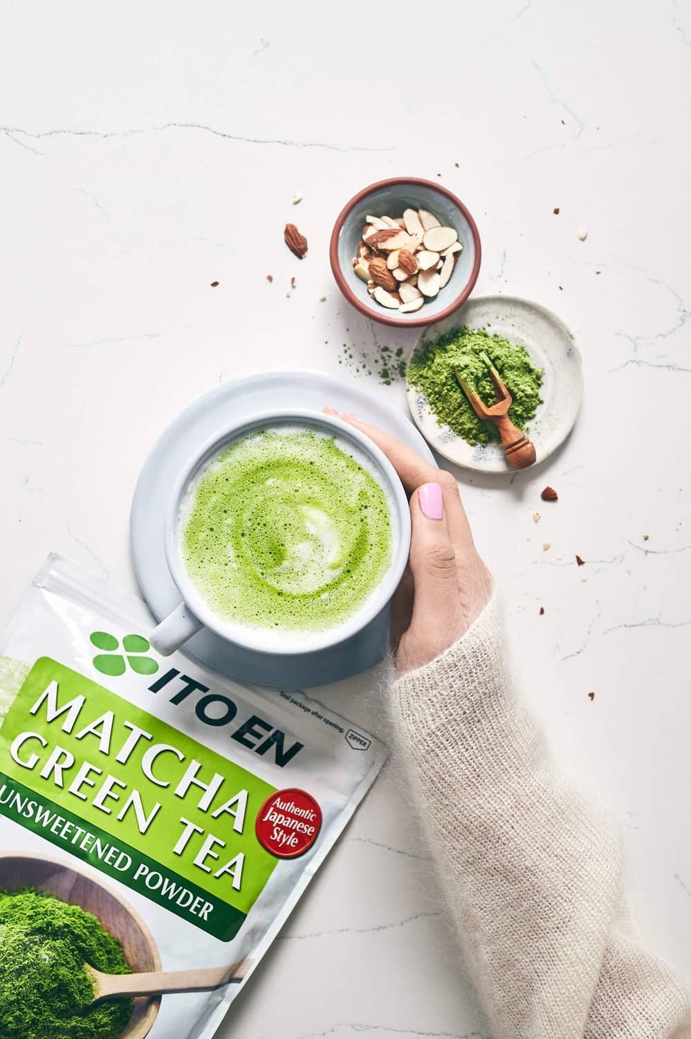 Ito En matcha green tea unsweetened powder pouch with latte cup nearby