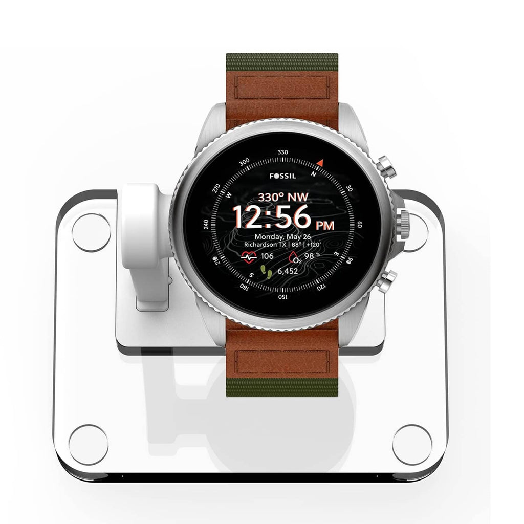 White charging stand holding a brown-banded smartwatch, 4-pin dock.