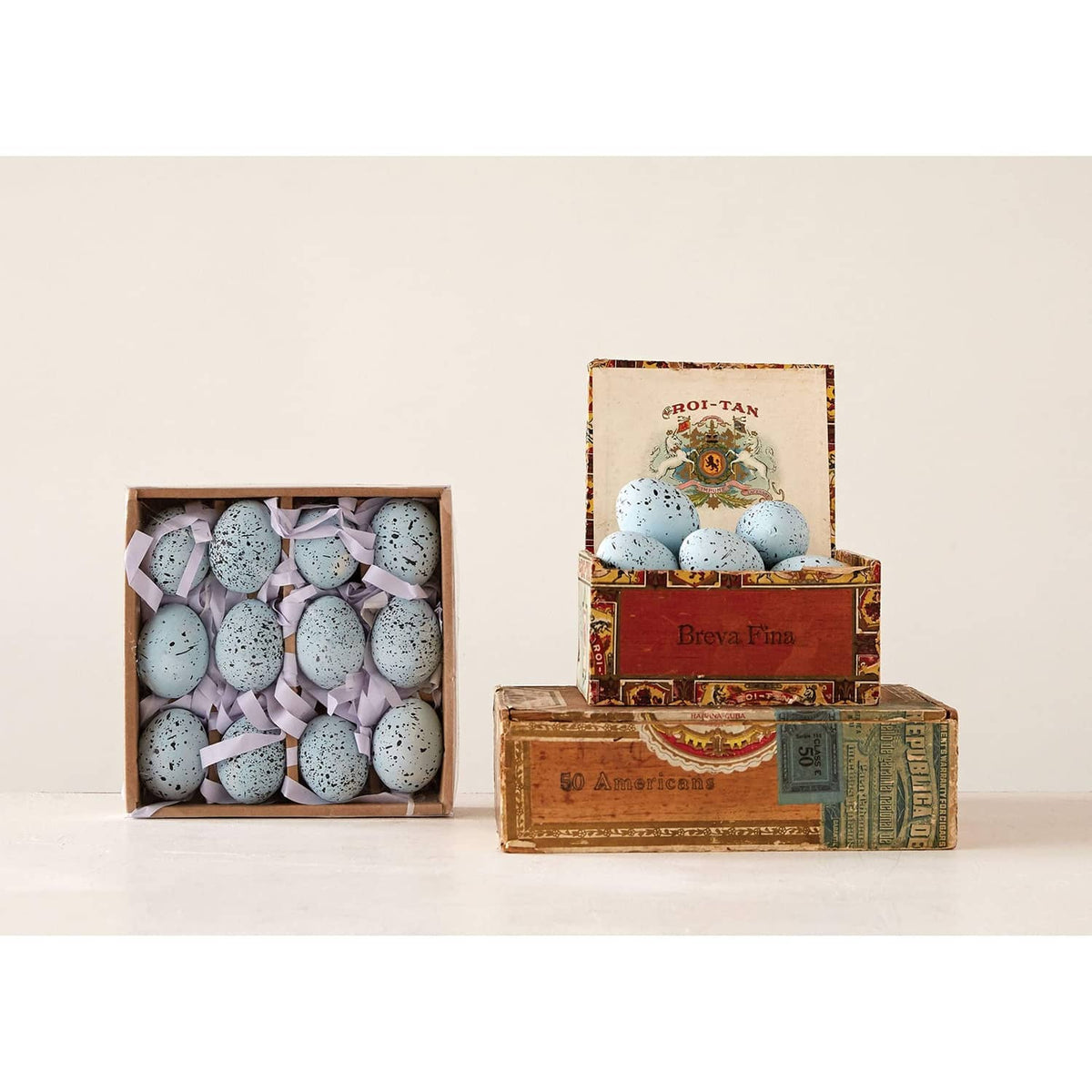 Boxed set packaging with blue speckled ceramic eggs in a fitted tray