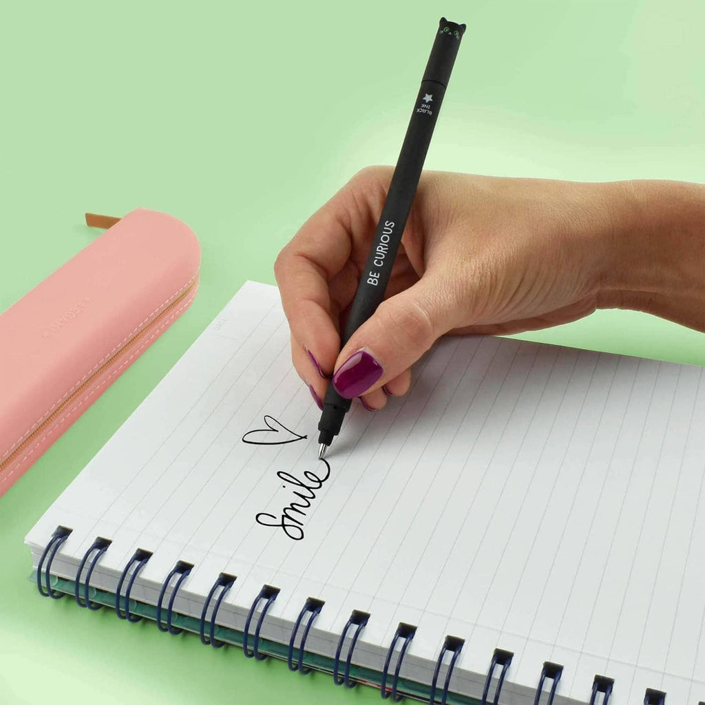 Black erasable gel pen in hand, writing on lined notebook paper