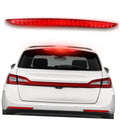 LED third brake light with red lens, mounted on rear hatch of a white SUV