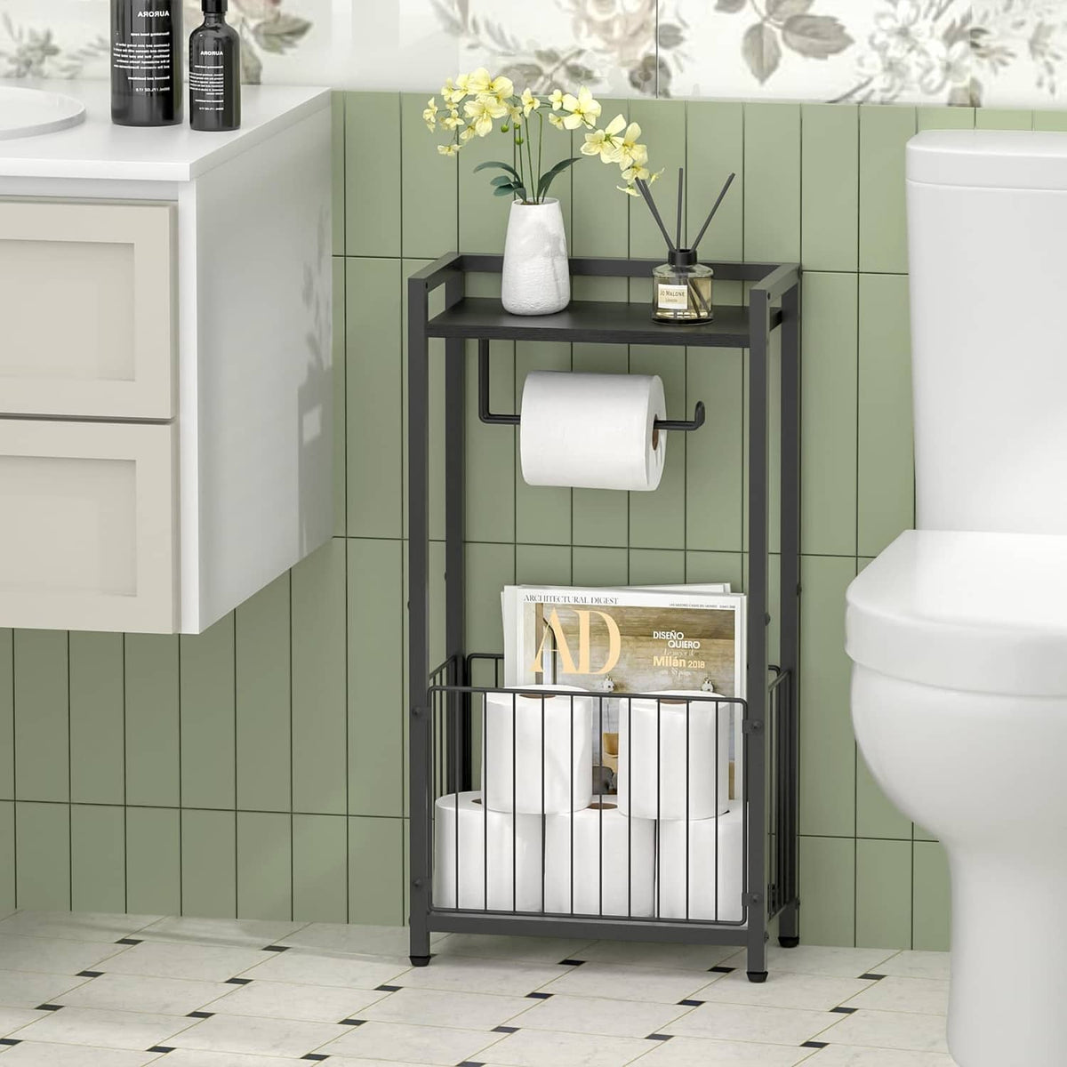 Black freestanding toilet paper holder with top shelf, tissue roll, and lower rack