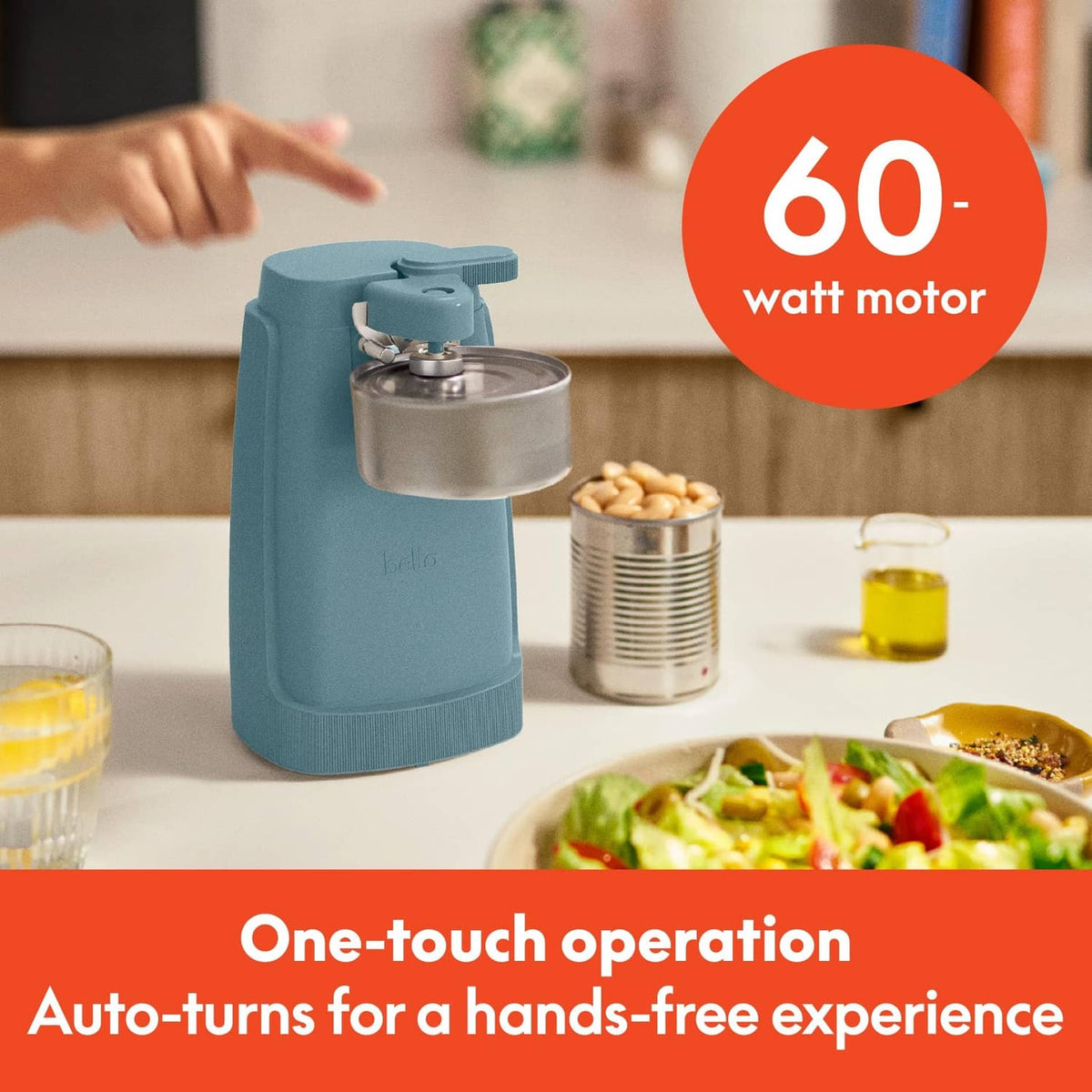 Teal electric can opener with one-touch lever, sits beside opened canisters on counter
