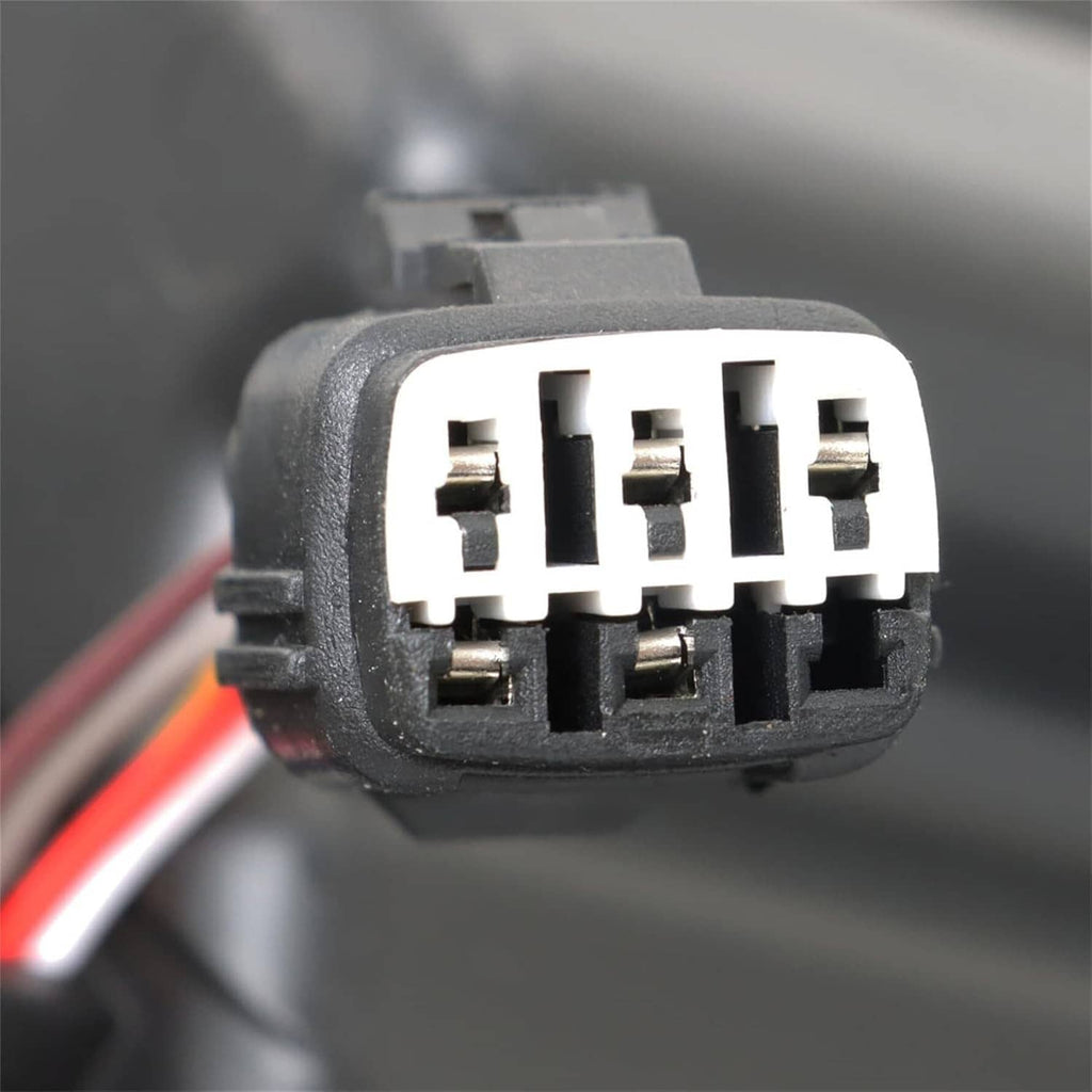 Close-up of multi-pin electrical connector on a headlight assembly.