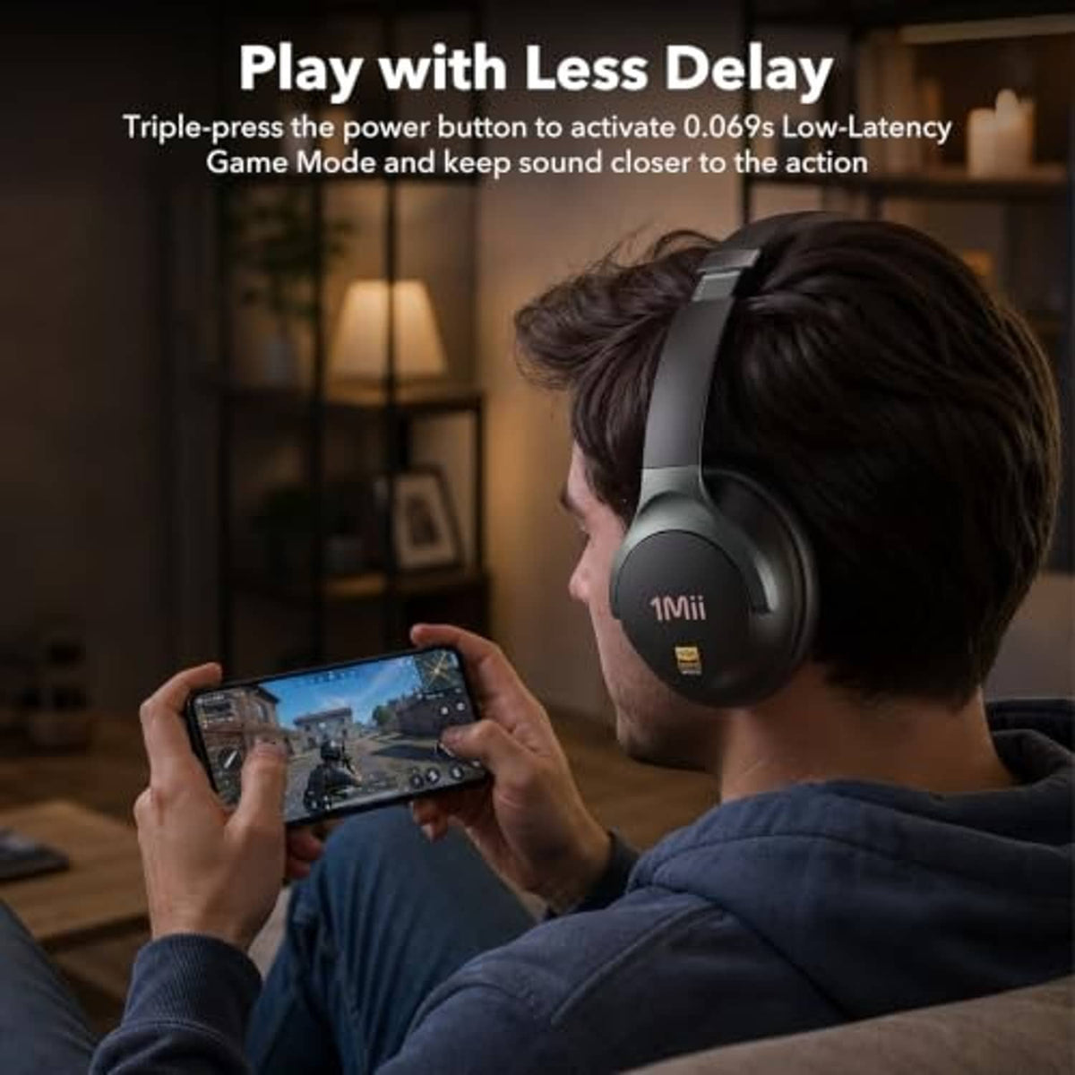 Black over-ear headphones worn by a gamer, with cushioned ear cups and headband.