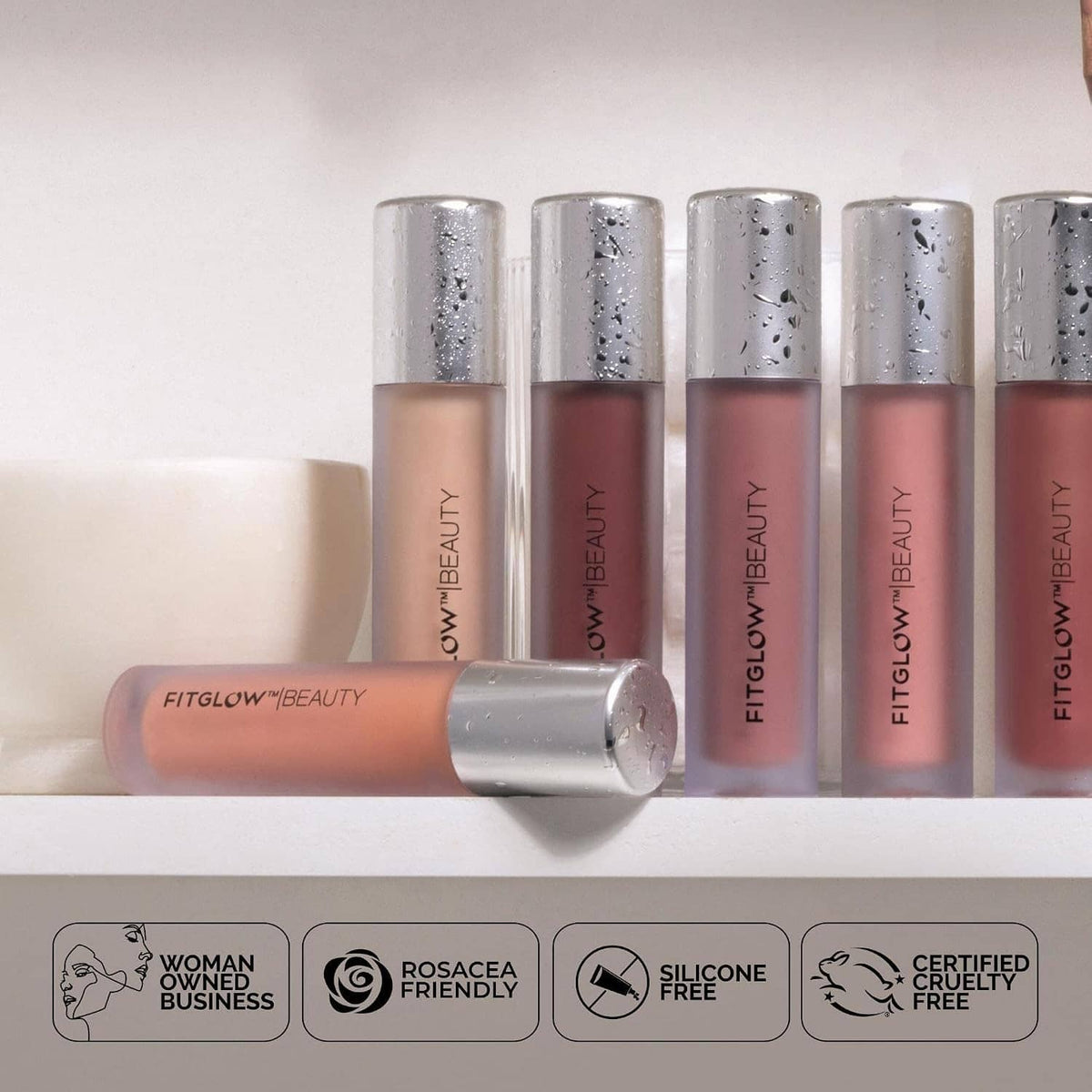 Collection of lip gloss serum tubes with silver caps in nude and rosy shades