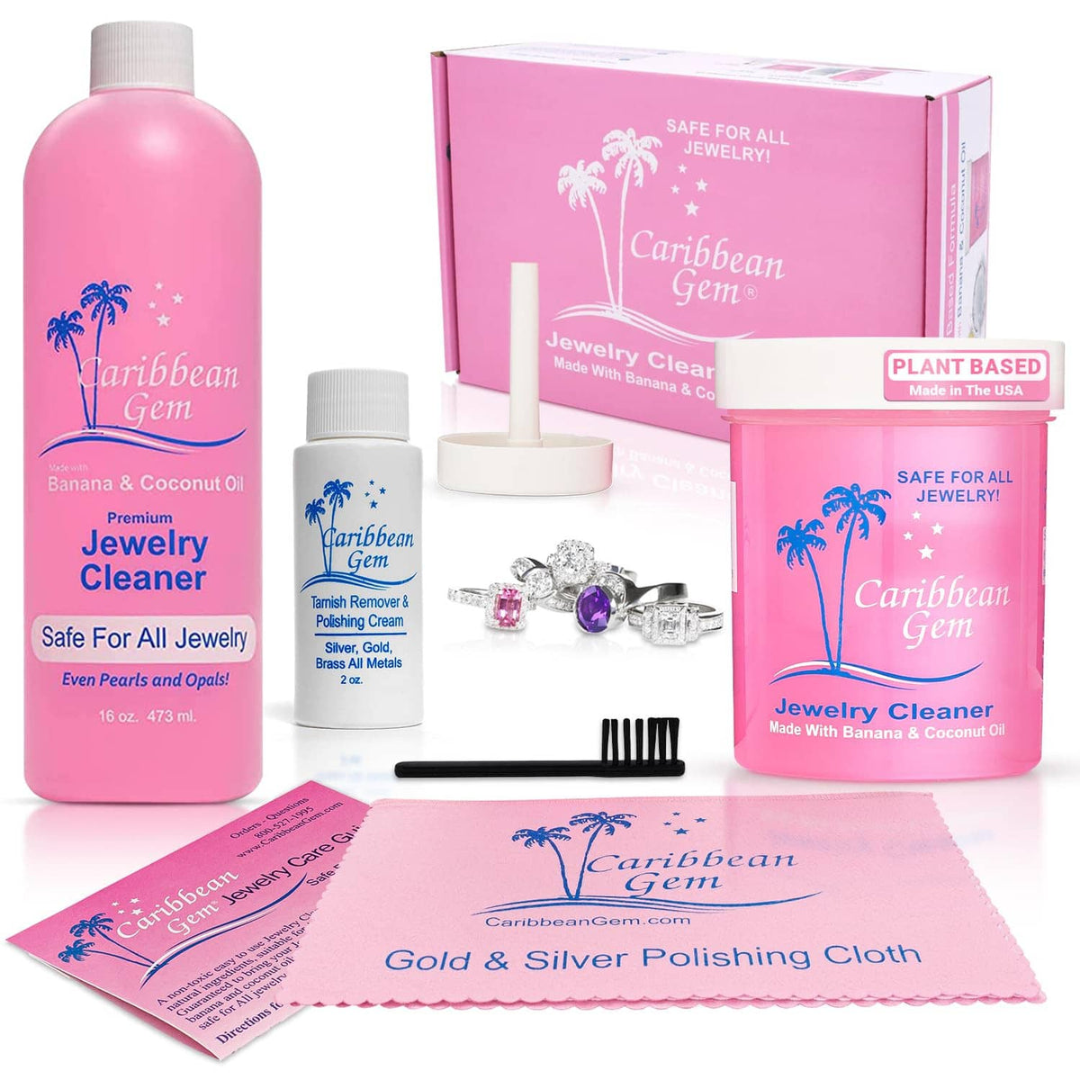 Jewelry cleaner kit showing cleaner bottles, basket brush, and polishing cloth on sheet