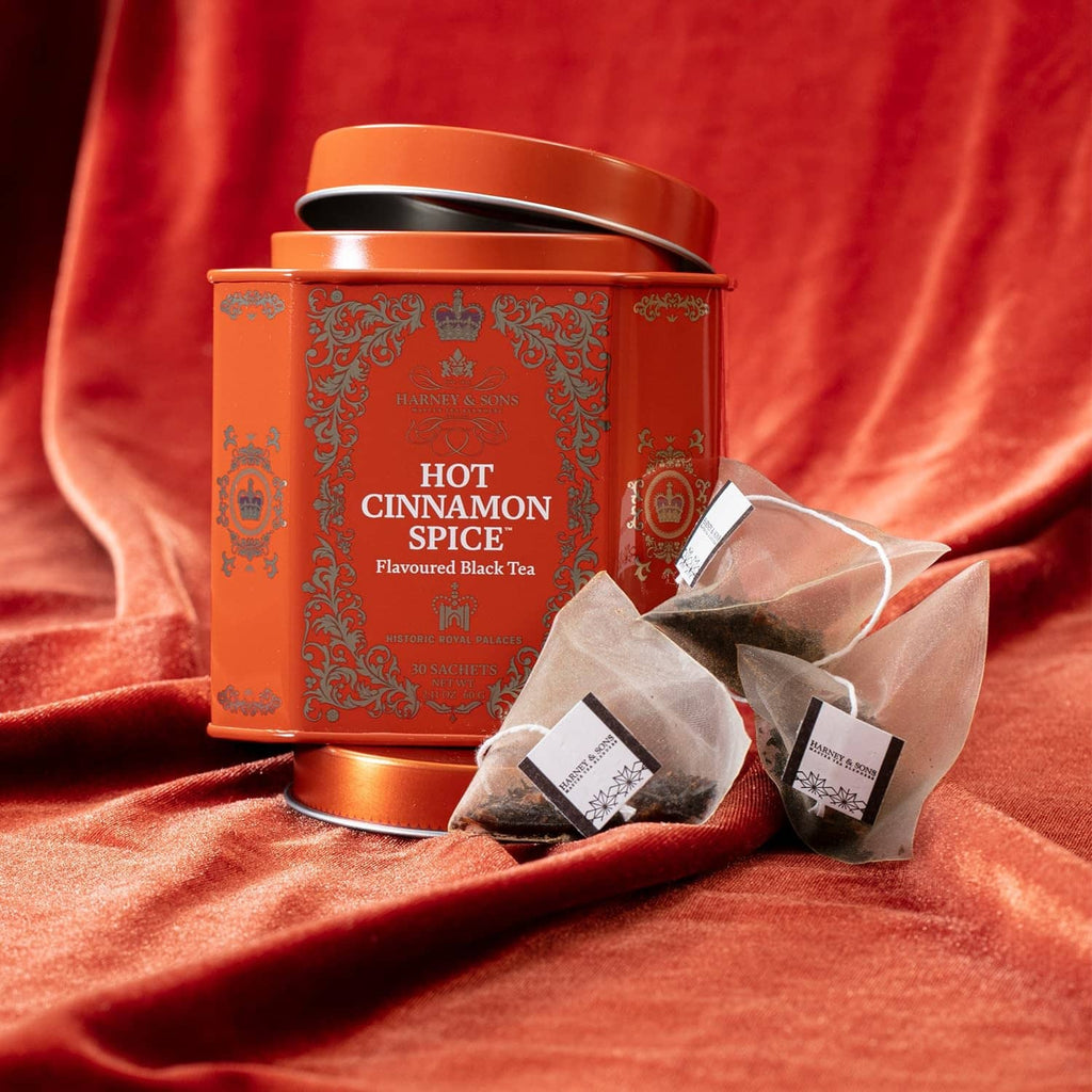 Orange Hot Cinnamon Spice tea tin with loose sachet packets beside it