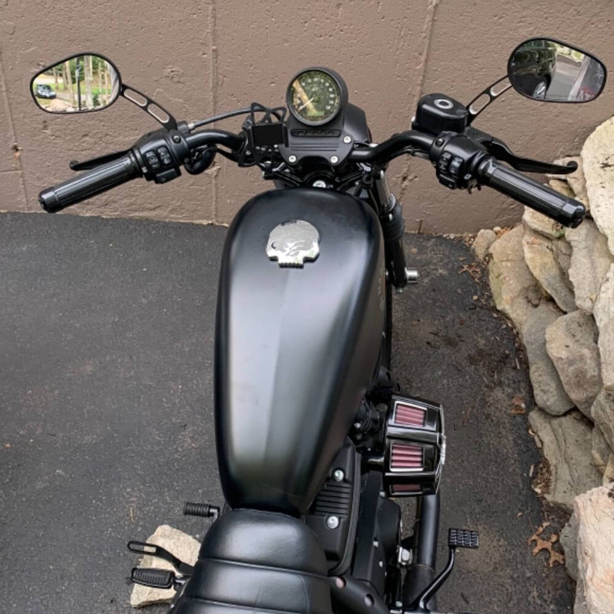 Black rear-view mirrors on motorcycle, oval housings with adjustment rods and bolts