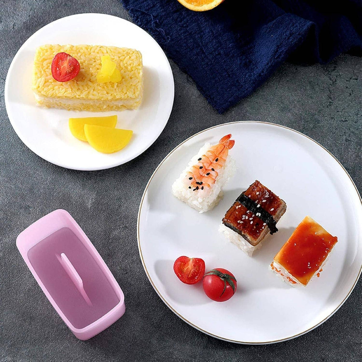 Prepared triangular rice balls with onigiri mold tray and press set on display