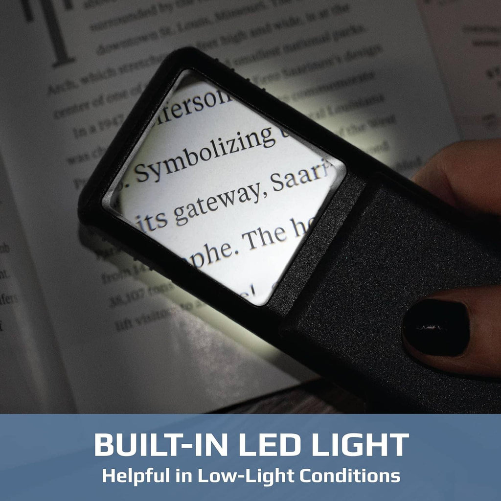 Black LED lighted magnifier held over printed text, lens window angled