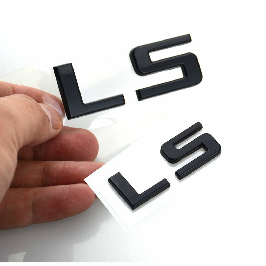 Gloss black LS emblem badges set, held in hand on white backing.