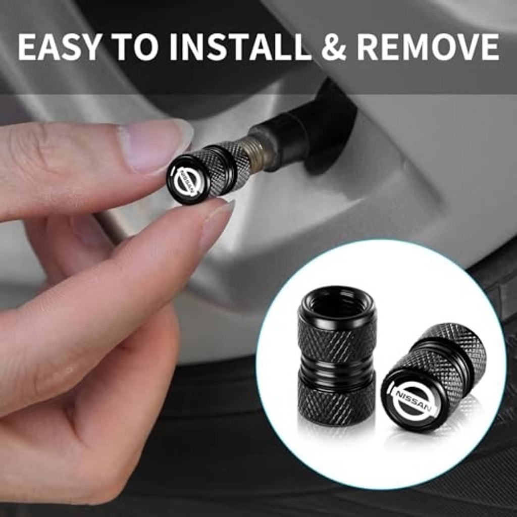 Black textured tire valve stem cap with Nissan logo, shown being installed