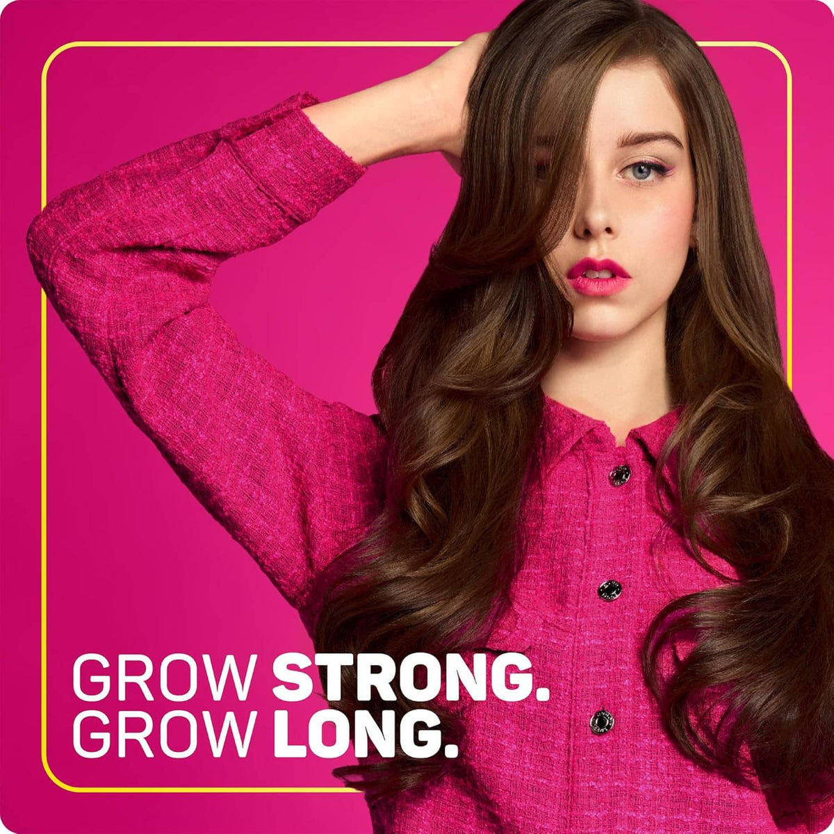 Woman with long wavy brown hair showcasing Grow Long styling