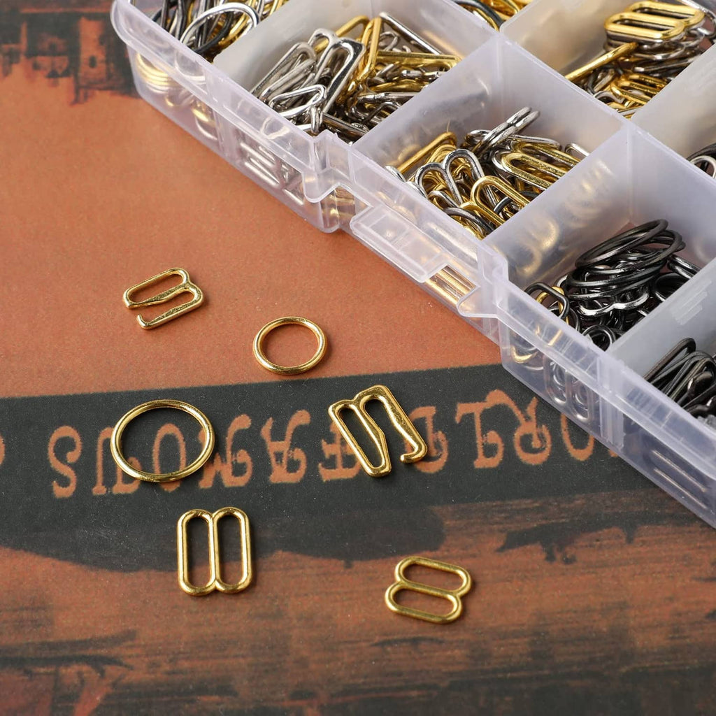 Loose metal bra strap hooks in gold and silver on brown surface, assorted styles