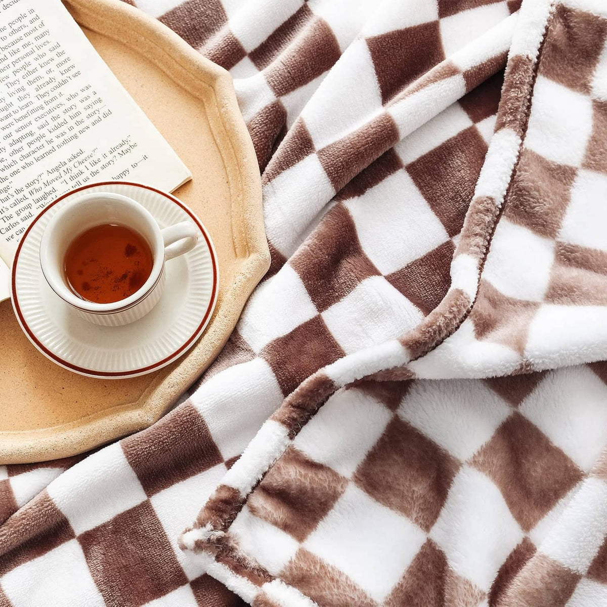 Flannel throw blanket close-up with coffee-brown and white checked pattern