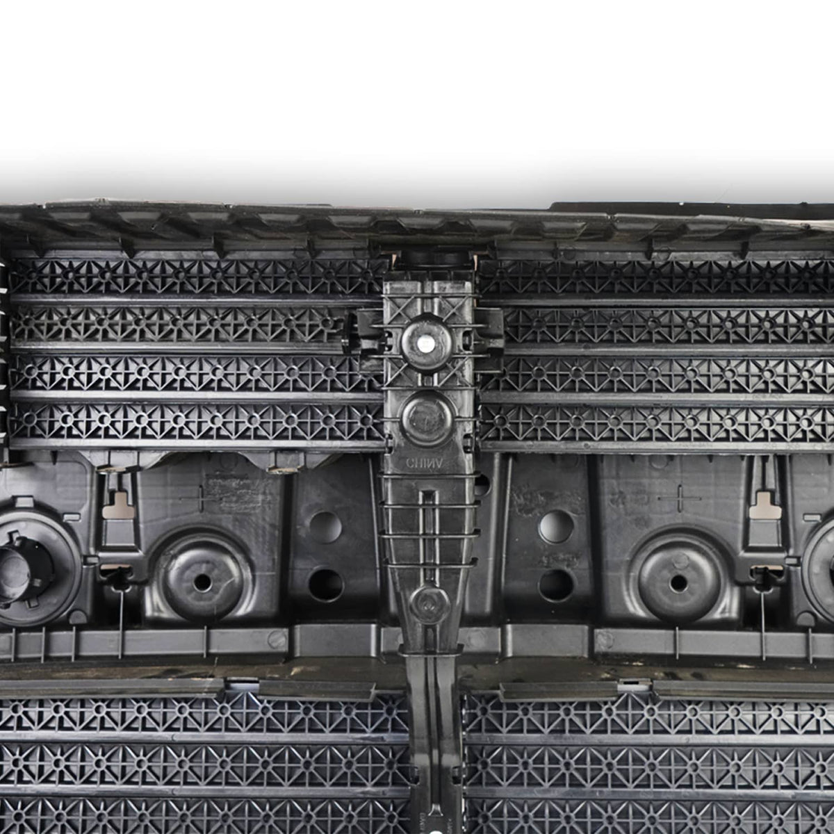Close-up of grille shutter assembly central mechanism and patterned grille inserts