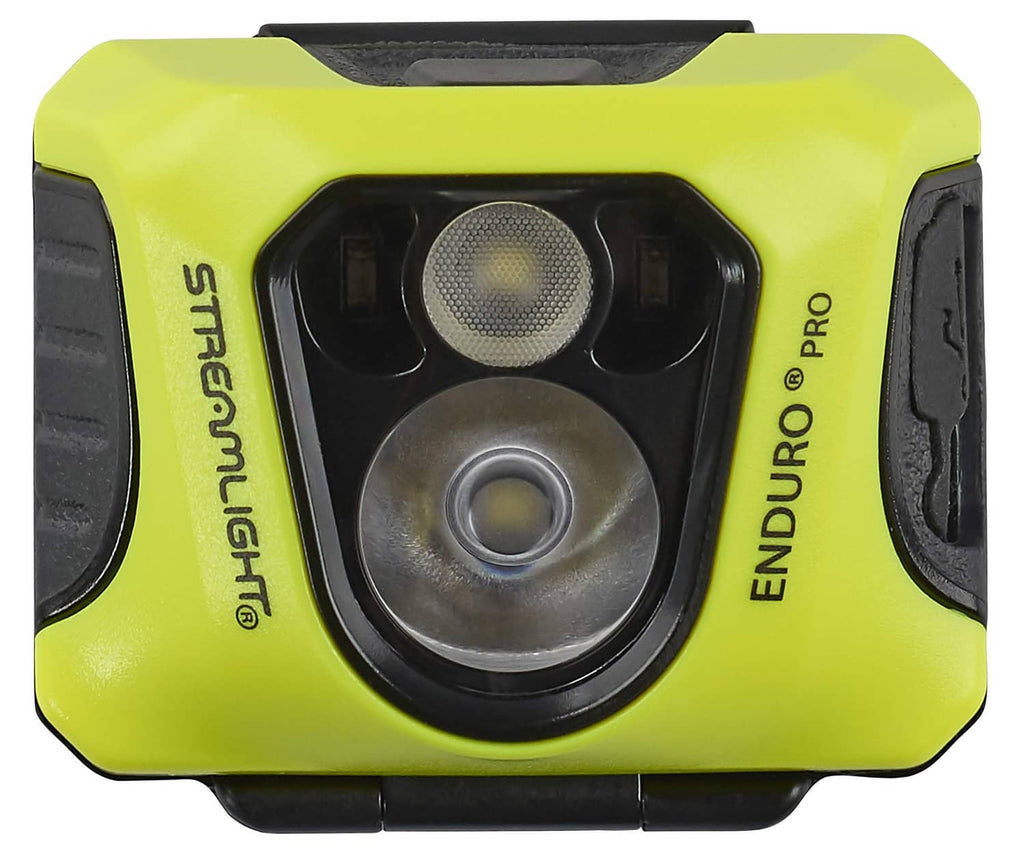 Yellow headlamp front view with central lens and side buttons on black housing